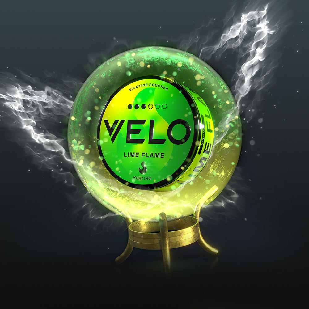Velo Nicotine Pouches |  A glowing green VELO Lime Flame nicotine pouch tin sits inside a mystical, smoky crystal ball with swirling white and green energy on a dark background, capturing the intense allure of Velo pouches.