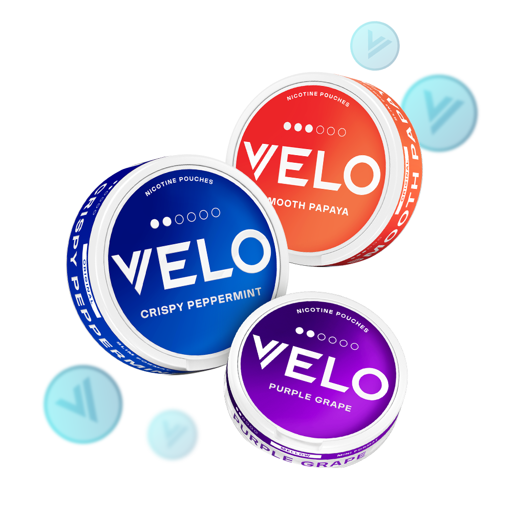 Velo Nicotine Pouches |  Three round Velo nicotine pouch containers in blue (Crispy Peppermint), orange (Smooth Papaya), and purple (Purple Grape) are displayed, with floating blue discs featuring a “V” logo swirling around the pouches.