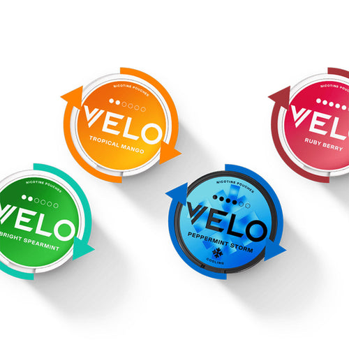 Velo Nicotine Pouches |  Four round Velo nicotine pouch containers in orange (Tropical Mango), red (Ruby Berry), green (Bright Spearmint), and blue (Peppermint Storm) are arranged on a white background, each surrounded by colored arrows highlighting the variety of Velo pouches.