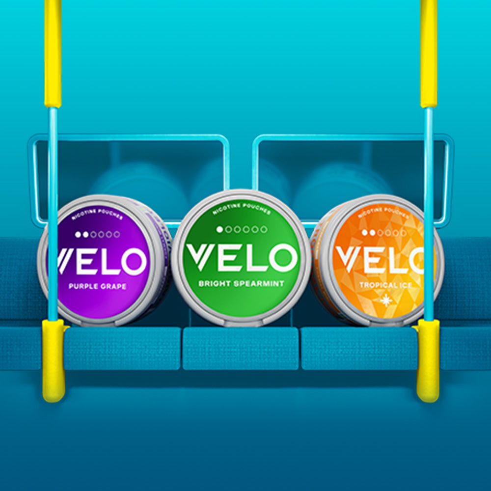 Velo Nicotine Pouches |  Three VELO nicotine pouch containers—purple grape, bright spearmint, and tropical ice—are displayed on a blue bench swing with a bright blue background. Yellow swing ropes frame the image, highlighting the vibrant design of these Velo pouches.