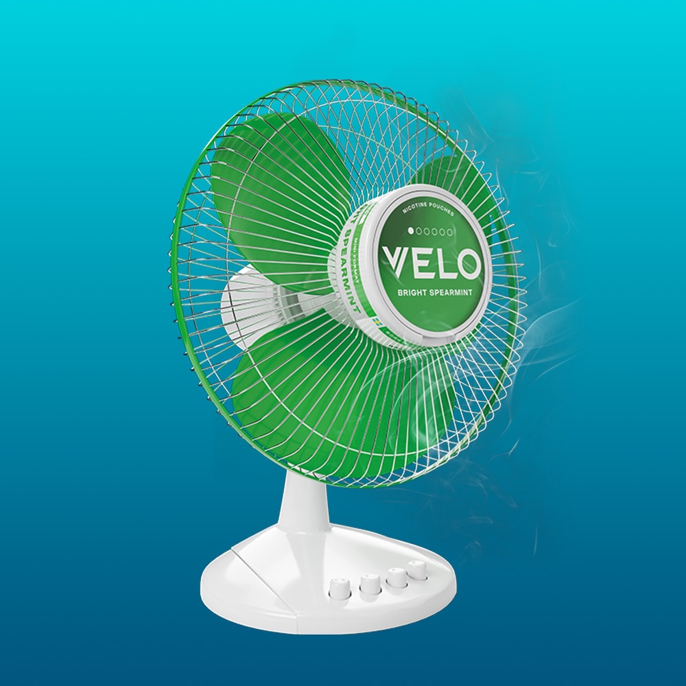 Velo Nicotine Pouches |  A white and green electric fan has a VELO Bright Spearmint nicotine pouch can as its center, set against a blue gradient background, highlighting the refreshing appeal of Velo pouches.