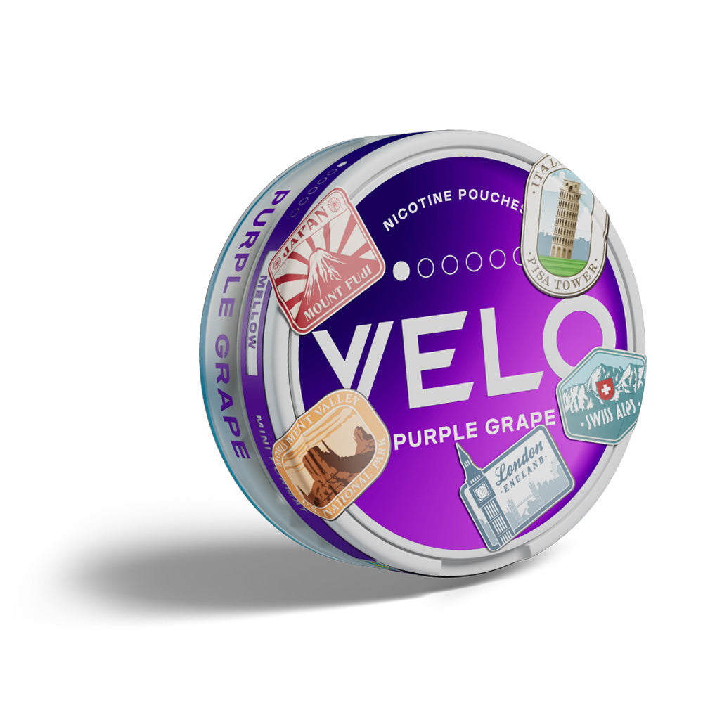 Velo Nicotine Pouches |  A round tin labeled VELO Purple Grape with nicotine pouches, featuring stickers of famous landmarks like Mount Fuji and the London Eye on the lid. The purple gradient design highlights the Velo branding, while a slight shadow adds depth to the sleek tin.