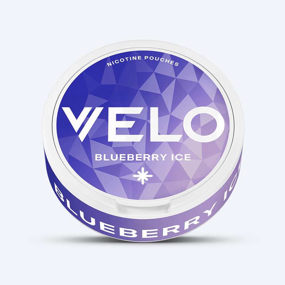 Velo Nicotine Pouches |  A round container of VELO Blueberry Ice, featuring a striking purple geometric pattern on the lid and bold white text for both the brand and flavor. Enjoy a delicious tart blueberry taste paired with a cool, refreshing sensation in each nicotine pouch.