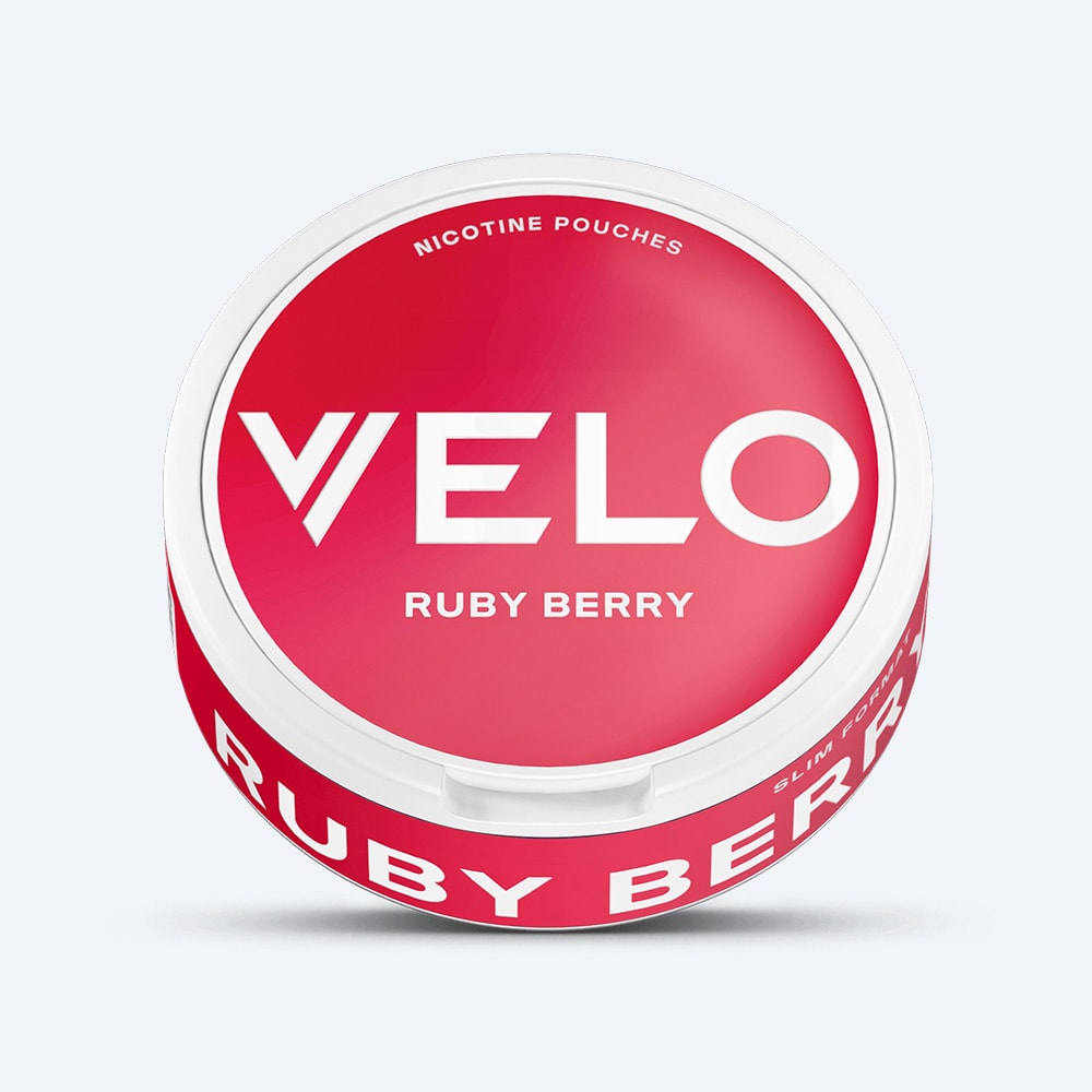 Velo Nicotine Pouches |  A round white container labeled VELO Ruby Berry features a red and white design and contains nicotine pouches with a refreshing blend of strawberry notes and subtle acidity.