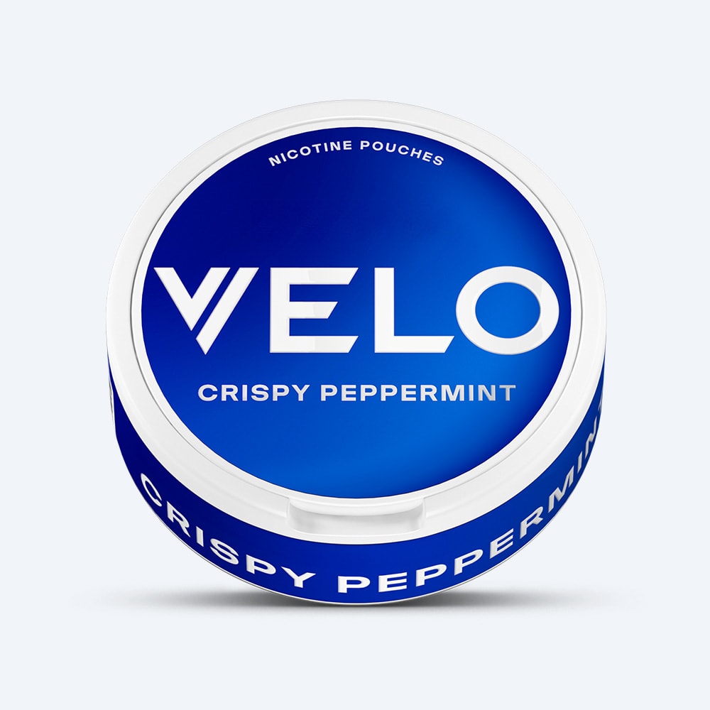 Velo Nicotine Pouches |  A round blue and white container labeled VELO Crispy Peppermint, designed for nicotine pouches, is displayed on a white background and offers a refreshing peppermint flavor with a cooling aftertaste.
