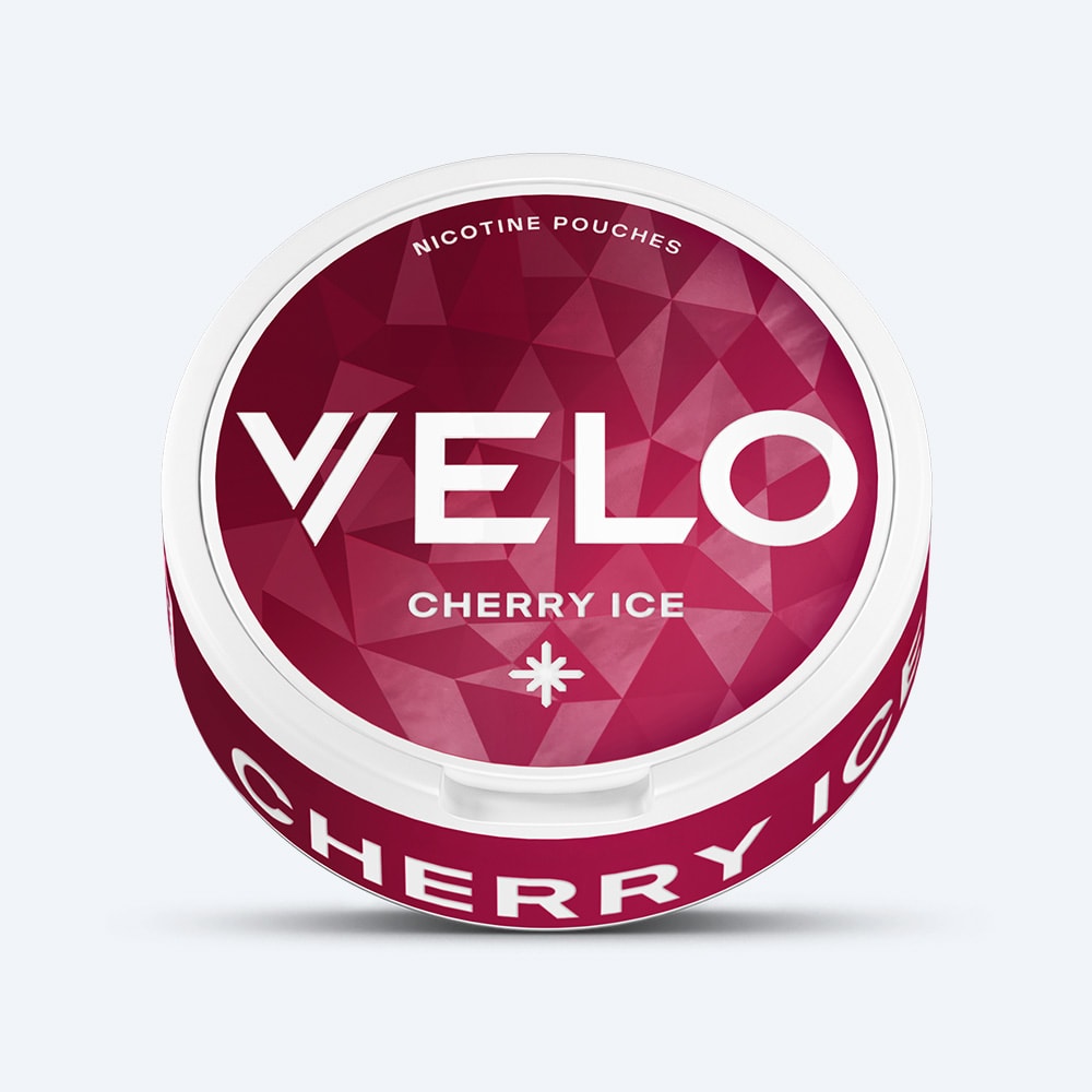 Velo Nicotine Pouches |  A round container of VELO Cherry Ice, featuring a red geometric design and bold white text on the lid and side, showcases the vibrant cherry ice flavour and its refreshing cooling effect.