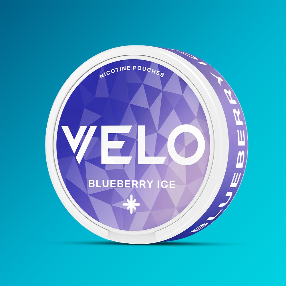 Velo Nicotine Pouches |  A round can of VELO Blueberry Ice nicotine pouches features a geometric purple design with bold white text on a blue gradient background and delivers a tart, fruity blueberry flavor with an invigorating cooling sensation.