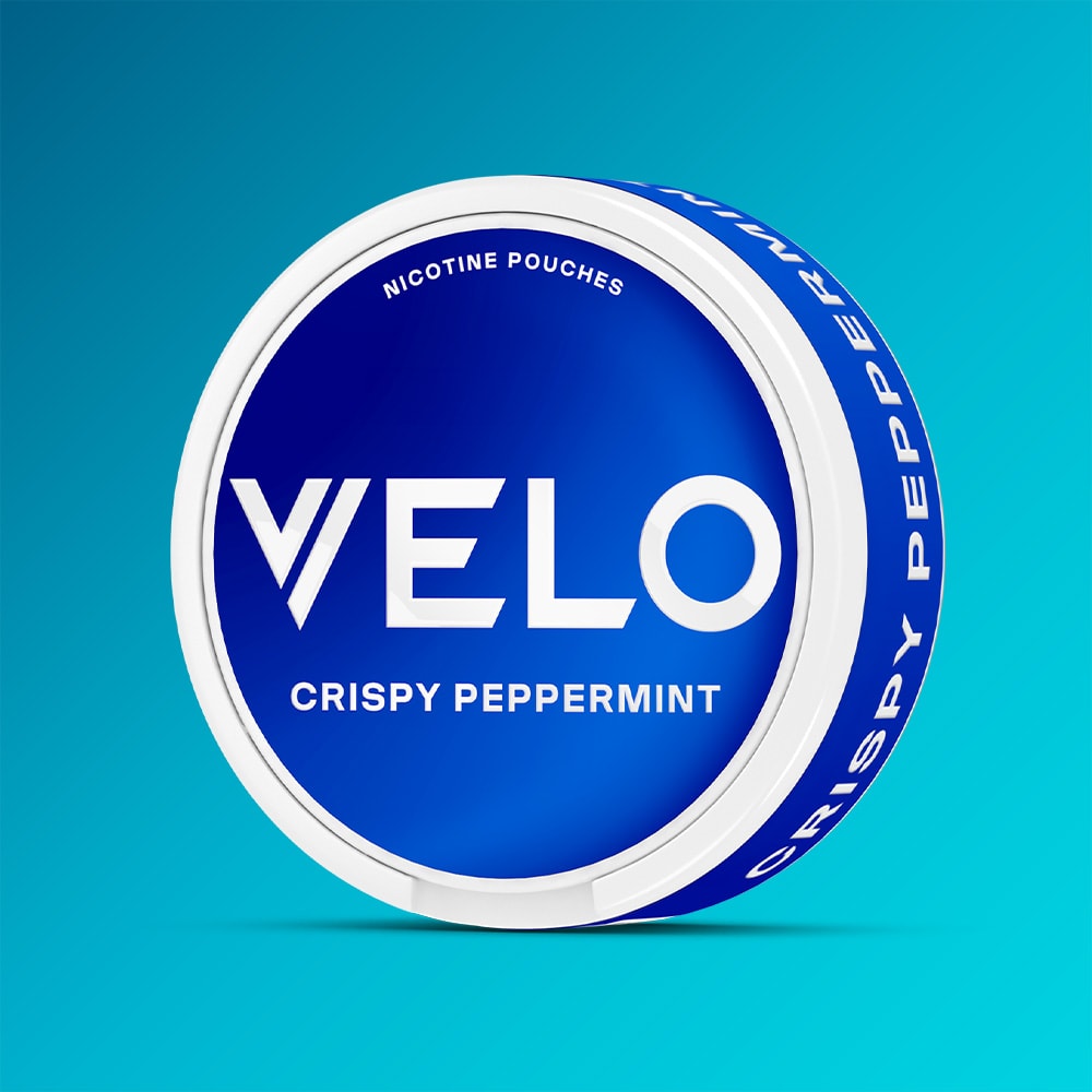 Velo Nicotine Pouches |  A round blue and white container labeled VELO Crispy Peppermint sits against a gradient blue background, suggesting the refreshing cooling aftertaste that VELO is famous for.