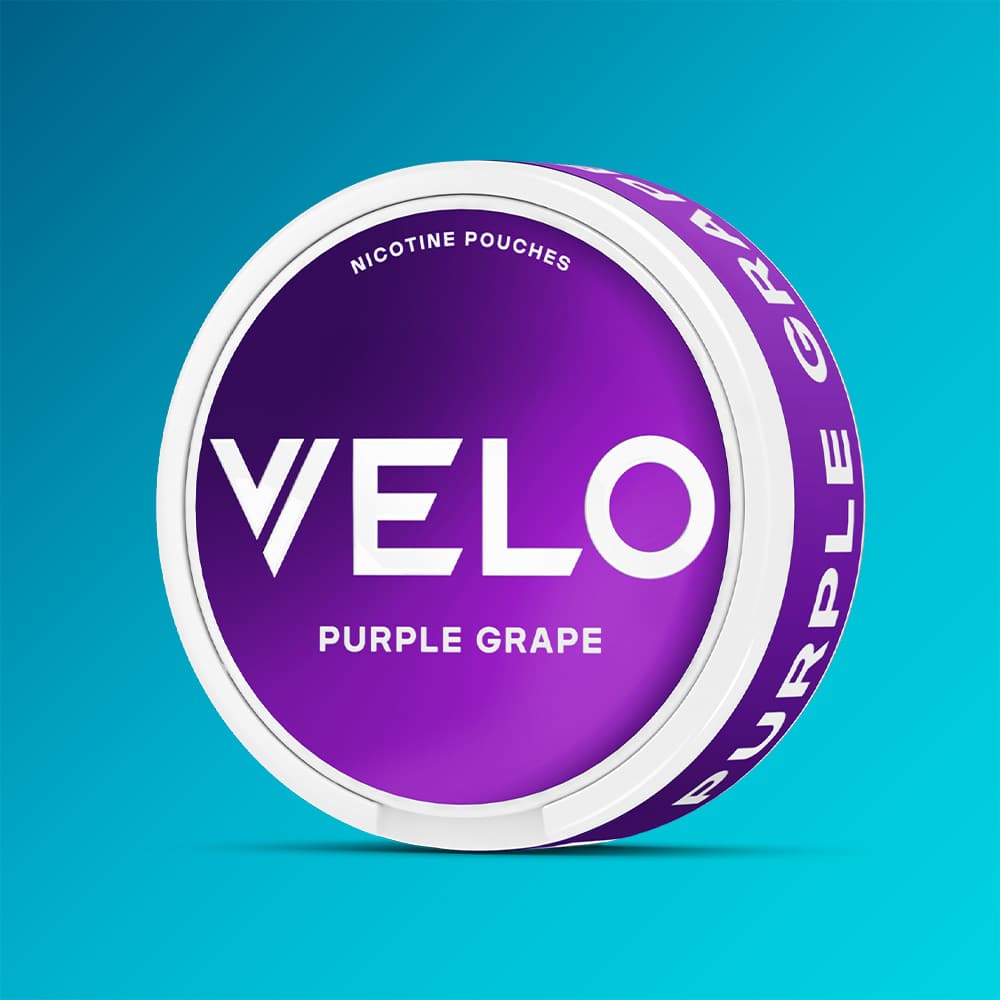 Velo Nicotine Pouches |  A round can of VELO Purple Grape, featuring a purple label with white text and a white rim, evokes the taste of juicy red grapes and is displayed against a blue gradient background.
