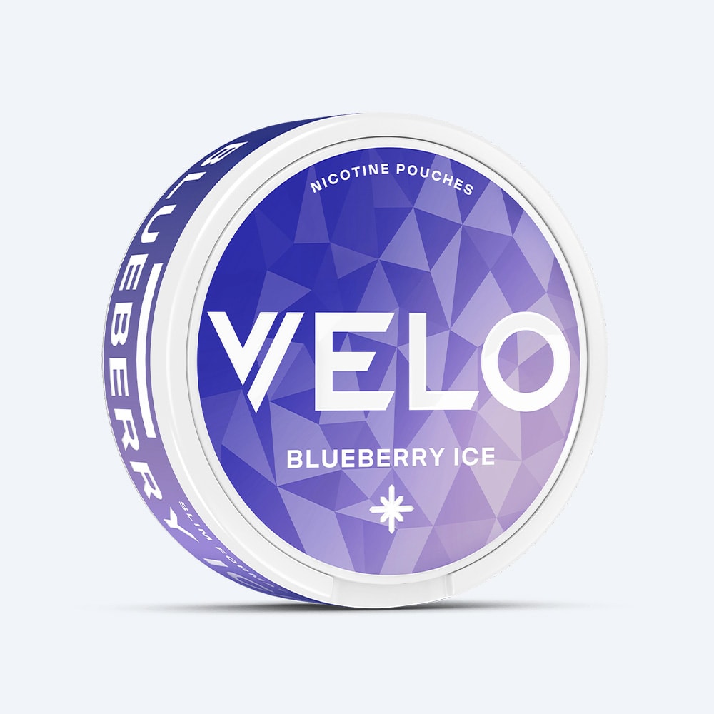 Velo Nicotine Pouches |  A round can of VELO Blueberry Ice features a geometric purple and blue design accented by bold white text on the lid, offering a fruity and tart blueberry flavor combined with a refreshing cooling sensation.