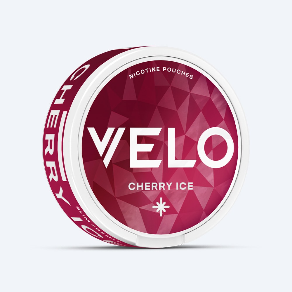 Velo Nicotine Pouches |  A round container of VELO Cherry Ice features a geometric red and pink design with white text on the lid, emphasizing the fruit flavor and refreshing cooling sensation of cherry ice.