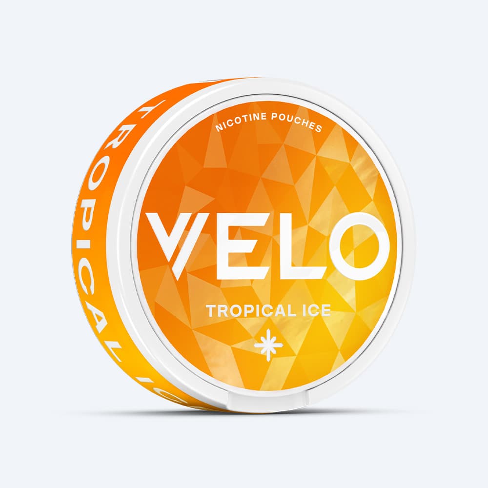 Velo Nicotine Pouches |  A round container of VELO Tropical Ice features an orange and yellow geometric design with white text and a white lid, offering a refreshing fruit flavor combined with a cooling sensation for an invigorating experience.