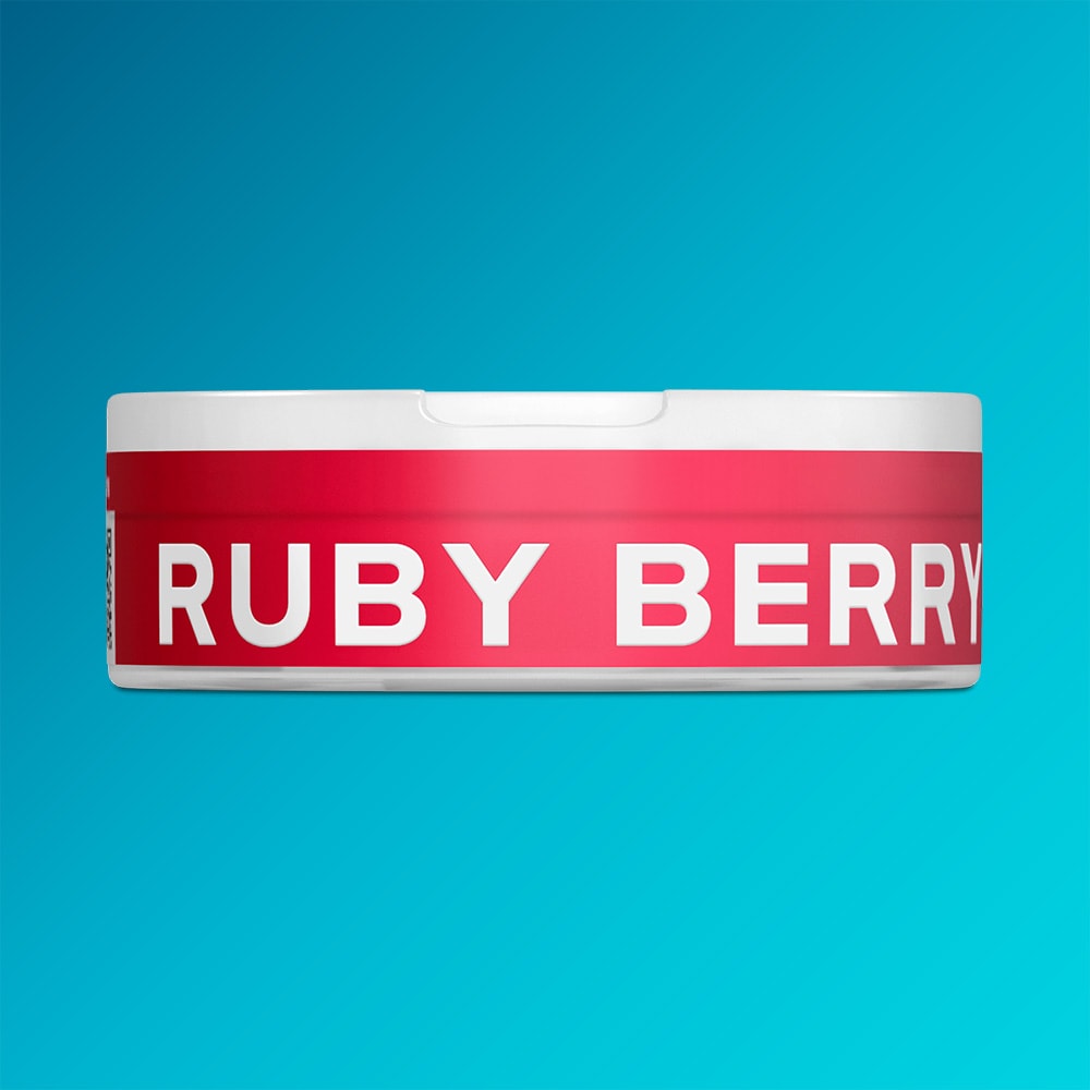 Velo Nicotine Pouches |  A round white container with a vivid red label prominently features the text "VELO RUBY BERRY" in large, white capital letters, set against a blue gradient backdrop. This eye-catching packaging reflects the vibrant strawberry blend inside Ruby Berry by VELO, celebrated for its delicate acidity and invigorating flavor profile.
