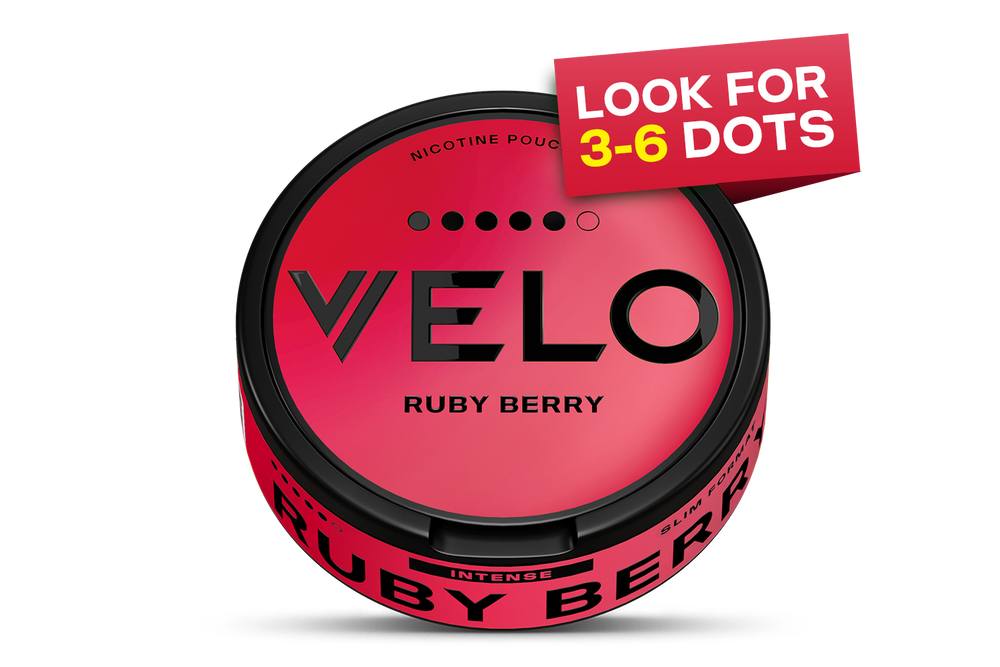 Velo Nicotine Pouches |  A round can labeled VELO RUBY BERRY with a pink-red gradient and black text. A banner says LOOK FOR 3-6 DOTS above five black dots on the lid. The can rim also reads RUBY BERRY. This sleek Velo container holds nicotine pouches, combining convenience with bold flavor in every pack.