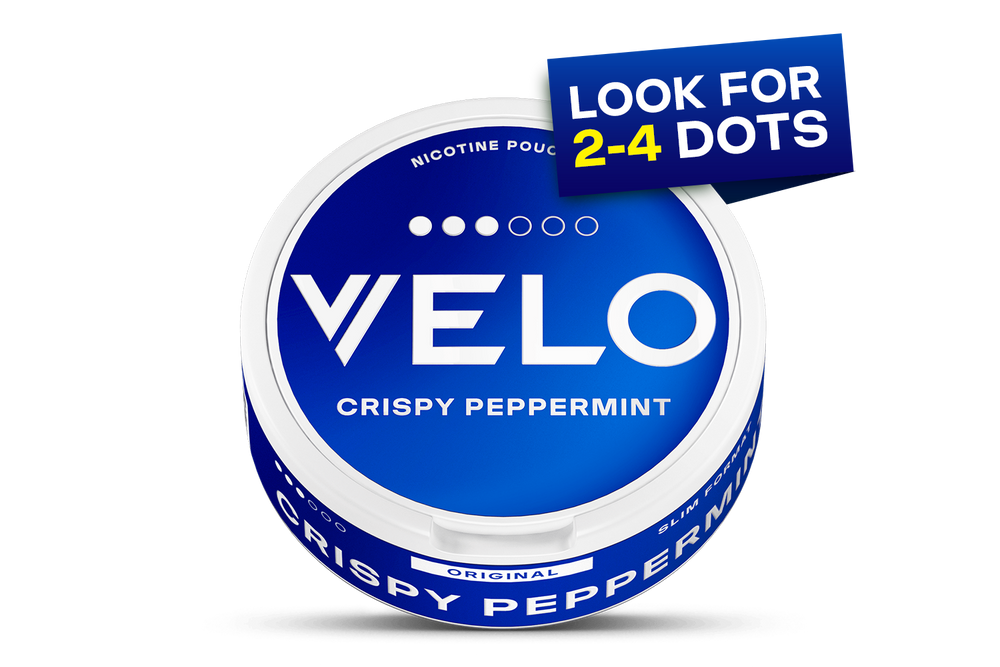 Velo Nicotine Pouches |  A round blue VELO nicotine pouch container labeled CRISPY PEPPERMINT sits prominently, with a sign saying LOOK FOR 2-4 DOTS and four white dots above the logo, highlighting the innovative pouches inside.